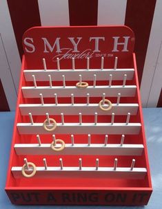 a red and white rack with gold rings on it