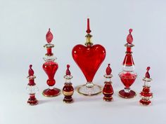 an assortment of red and gold glass items