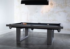 a pool table in a room with a light on the ceiling and two billiards