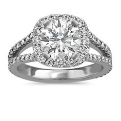 a diamond engagement ring with two rows of diamonds on the band and an oval center stone surrounded