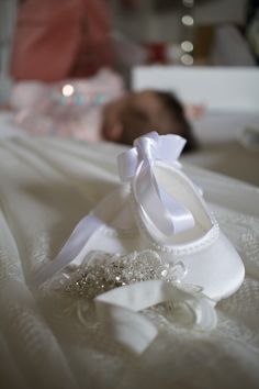 a pair of white shoes sitting on top of a bed