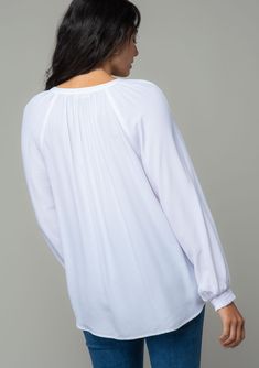 A classic bohemian button-front blouse in a soft and silky crepe. Silky crepe Relaxed fit Long voluminous sleeve Smocked elastic wrist cuff Split v-neckline Button front Bohemian blouse For the office and beyond, this classic button-front blouse is the go-to style of the season. Designed in a soft and silky crepe. Featuring voluminous long sleeves, smocked elastic wrist cuffs, and an ultra-relaxed fit. Model is 5'9, wearing a size S.Style: I-13877W-RPL Chic V-neck Smocked Top With Blouson Sleeves, Bohemian V-neck Top With Smocked Back, Elegant V-neck Peasant Top For Fall, Bohemian V-neck Tops With Smocked Back, V-neck Smocked Top For Brunch, Spring V-neck Peasant Top With Blouson Sleeves, Casual Flowy V-neck Peasant Top, Elegant Peasant Top With Balloon Sleeves, Casual V-neck Peasant Top With Smocked Bodice