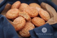 a basket filled with cookies on top of a blue cloth