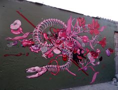 a large mural on the side of a building with pink and red flowers painted on it