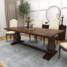 a dining room table with chairs and a potted plant in the center on top