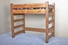 a wooden bunk bed sitting on top of a carpeted floor next to a wall