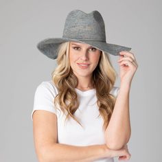 Be ready for any outdoor occasion in style with the Marina Women's Crochet Raffia Fedora. This exquisite fedora is crafted with 100% Crochet Raffia and features a 4" brim and adjustable size to fit perfectly. Choose between a brown, blue, or natural hue with the unique addition of twisted cording and bow in the center back. Elevate your ensemble and be the talk of the town in this one of a kind fedora. Features: Colors: Brown, Blue, & NaturalMaterials: 100% Crochet RaffiaBrim Size: 4" BrimSize: Fitted Fedora Hat With Upf 50+, Casual Blue Sun Hat For Kentucky Derby, Casual Wide Brim Blue Crochet Hat, Blue Brimmed Panama Hat Casual Style, Casual Blue Brimmed Panama Hat, Blue Flat Brim Panama Hat For Spring, Blue Sun Hat With Curved Brim For Country Events, Fitted Brimmed Crochet Hat, Blue Curved Brim Sun Hat For Country Events