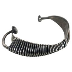 This modernist sculptural piece is one of Wiener's first creations as a jeweler-artist, in New York City, circa 1954.This cuff bracelet is composed of two simple aerodynamic pieces with sinuous curved shapes wrapped by an infinite wire, which in turn recreates a sculpture with constructivism patterns,, Stunning iconic piece of modernist jewelry.. Has a weight of 34.6 grams and fit a wrist up to 7 inches. Modern Hand Forged Metal Bracelet, Modern Oxidized Finish Cuff Bracelet Bangle, Contemporary Metal Cuff Bracelet, Modern Oxidized Finish Cuff Bangle Bracelet, Modern Oxidized Cuff Bracelet Bangle, Modernist Metal Bangle Jewelry, Unique Oxidized Metal Cuff Bracelet, Contemporary Sterling Silver Bangle Bracelet, Modern Adjustable Oxidized Bracelet