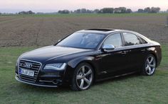 a black car parked in the middle of a field