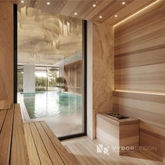 an indoor swimming pool surrounded by wooden walls