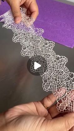 someone is working on an intricate doily design with scissors and yarn in their hands