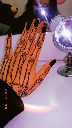 a person's hand painted with black and orange