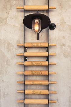 a light that is on the side of a wall next to a rack with baseball bats