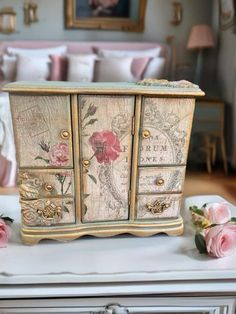 an old dresser has been decorated with flowers and other things to decorate on top of it