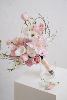 a vase filled with pink and white flowers