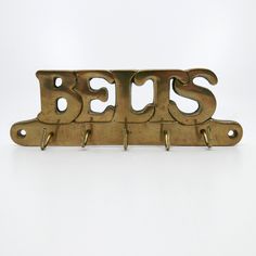 two brass metal hooks with the letters bss on them