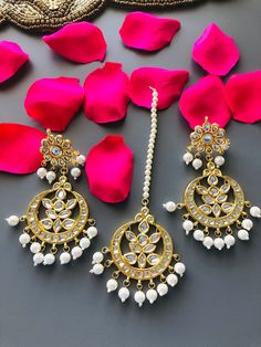 Kundan Chandbali Mang Tika Combo set/Kundan Chandbali/Kundan Mang Tika Features: 1- Base Metal Brass 2- Very high quality Kundan Stones 3- Length: Mang Tika- 7 Inches Earrings- 3.75 Inches 4- Traditional Earrings and Mang Tika Combo Set 5- Earrings come with Push Back closure White Chandbali Jewelry Sets For Puja, Kundan Danglers For Puja And Festivals, White Chandbali Jewelry For Rituals, White Kundan Set For Puja, Traditional Chandbali Jewelry Set With Latkans, White Hand-set Chandbalis For Diwali, Bollywood Kundan Chandbalis For Rituals, Bollywood Chandbali Jewelry Sets For Puja, White Hand Set Chandbalis For Diwali