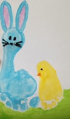 a child's drawing of a blue bunny and yellow duck sitting next to each other