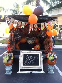 the back of a car decorated with pumpkins and decorations