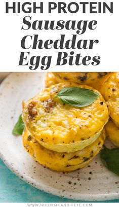 high protein sausage cheddar egg bites on a white plate with green leaves and text overlay