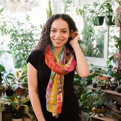 Model wearing a one of a kind sari silk medley scarf tied around their neck with assorted plants in the background. Sari Scarf, Organic Clothing Women, Beautiful Scarf, Recycled Sari Silk, Colorful Gifts, Sari Silk, Eco Friendly Fashion, Silk Scarves, Head Scarf