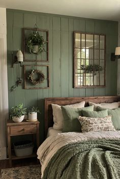 a bed sitting in a bedroom next to two mirrors on the side of a wall