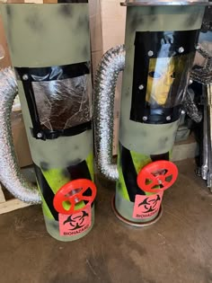 two green and black fire extinguishers sitting next to each other