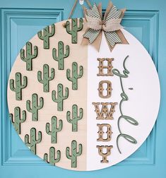 a wooden sign with the words home sweet and cactus decorations