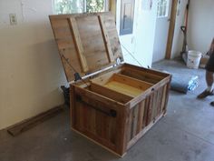 a large wooden box sitting on top of a floor next to a person walking by