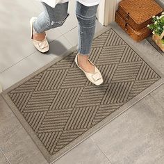 a woman standing in front of a door with her feet up on the door mat