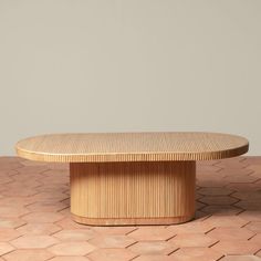 a wooden table sitting on top of a tiled floor