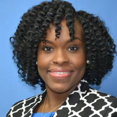 a close up of a person wearing a black and white jacket with an afro hairstyle