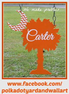 an orange sign with the word catter on it in front of a grassy field