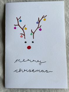 a christmas card with a reindeer's head and colorful lights on its nose that says merry christmas