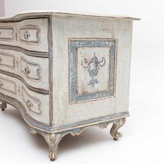 an old dresser with blue and white paint on it