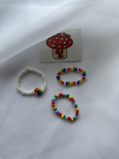 Rainbow beaded rings! White Flower Ring Perfect For Gifts, White Beaded Flower Ring As Gift, White Beaded Rings, White Beaded Flower Ring For Gift, Gift Flower Ring With Beads, White Bohemian Beaded Rings, Mushroom Seed Bead Ring, Beaded Flower Ring Gift, Multicolor Flower Ring With Colorful Beads As Gift