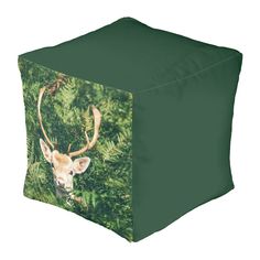 a deer's head is seen through the foliage on this green square pouff