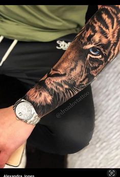 a man with a tiger tattoo on his arm