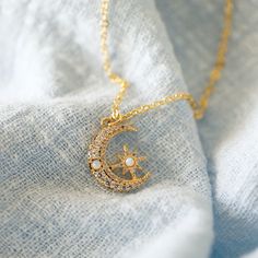 "Beautiful and lovely moon and star necklace made of dainty CZ stone and opal stone gold moon and star charm with skinny gold plated brass chain. Soft and warm looking necklace is good for yourself or gift ! Your necklace will ship in a rudiana gift box. ♥Length 14\" - 20\" ♥Moon and star charm 1/2\"x 5/8\" ♥Gold plated over brass / Cubic Zirconia / Opal stone ♥ Delivery Time Fast shipping within 1 - 3 days ♥ See more Rudiana Accessories Rudiana.etsy.com" Crescent Moon And Star Jewelry, Dainty Crescent Charm Necklace With Star, Gold Celestial Charm Necklaces With Birthstone, Celestial Gold Charm Necklace With Birthstone, Gold Celestial Charm Necklace With Birthstone, Dainty Gold-plated Moon Charm Necklace, Moon And Star Necklace, Unique Gold Jewelry Designs, Locket Design