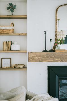 a living room filled with furniture and a fire place next to a wall mounted mirror