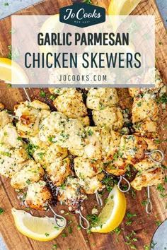 garlic parmesan chicken skewers on a cutting board with lemon wedges