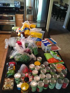 the kitchen counter is covered with food and condiments