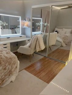 a bedroom with mirrored walls and white furniture