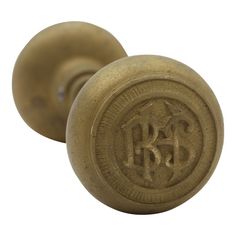 an antique brass door knob with the initials b & g on it's side