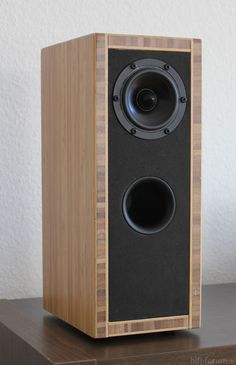 a wooden speaker sitting on top of a table