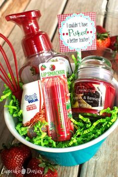 a bowl filled with lots of different items on top of a wooden table next to strawberries