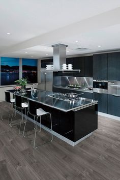 a modern kitchen with black cabinets and stainless steel appliances