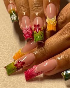 a woman's hand with some colorful nail art on it