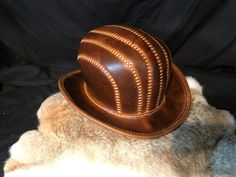 "Leather Steampunk Bowler Hat Made with Crazy Cow (Coach) Leather. This leather has some Amazing markings making each item a real one off. There is no way there will be another like this one, even if you use the same colour leather. Head Size is 60\" I can Make these to order if you need another size or colour then please do get in touch. Materials Used: 1.8mm-2mm Leather Wax Thread Curved Metal Wire Hat length - 33cm Hat Width - 28cm Hat height - 16cm All Hand Stitched. Please message us with any questions! Happy Shopping! Less" Vintage Leather Hat With Leather Sweatband, Steampunk Leather Hat Band With Short Brim, Steampunk Leather Brimmed Hat Bands, Steampunk Leather Hat For Festivals, Steampunk Leather Festival Hat, Vintage Leather Hat With High Crown, Steampunk Brown Leather Hat, Vintage High Crown Leather Hat, Brown Leather Steampunk Hat