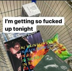 a shopping cart filled with books sitting next to each other